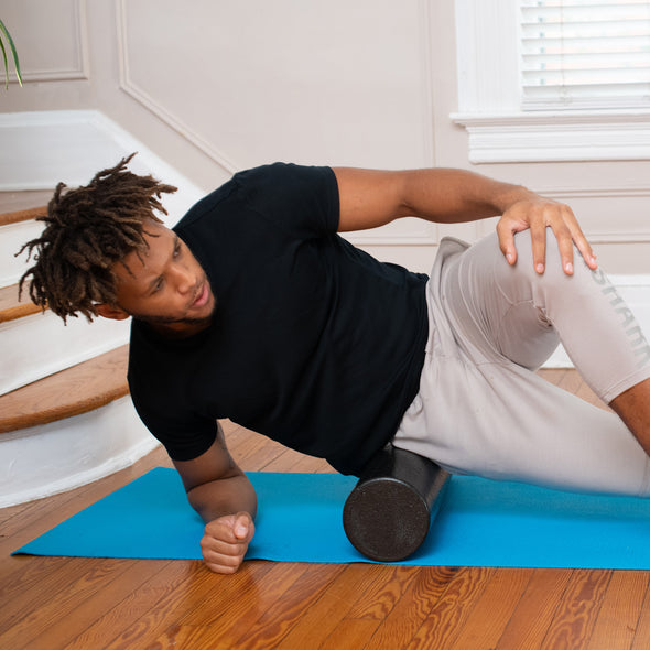 Man using EPE roller to massage hip area