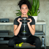 Woman performing squat with adjustable dumbbell