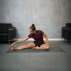 Woman stretching on 3mm grey yoga mat