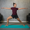 Woman practicing yoga on teal 3mm mat