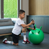 Child inflating Stay and Play ball with hand pump